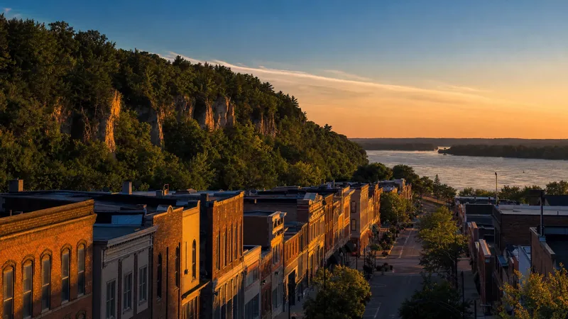A western Wisconsin river town with brick storefronts below wooded bluffs, La Crosse Business Licenses